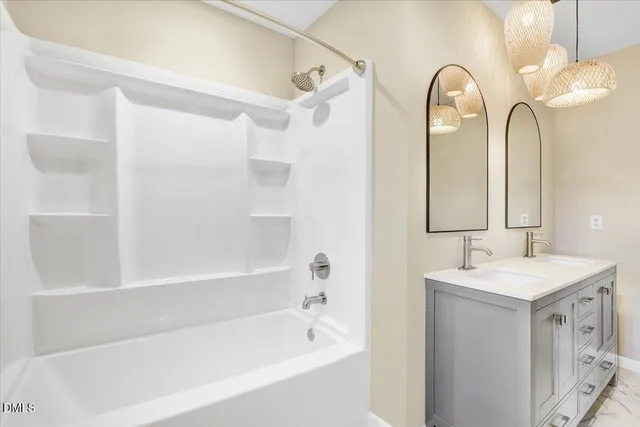 a bathroom with 2 sink and a mirror