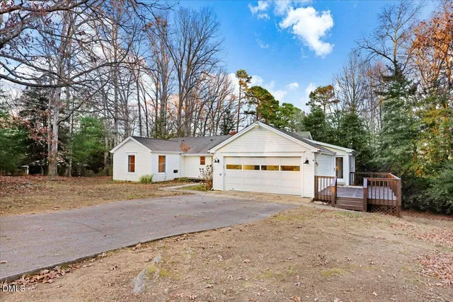 a view of a house with a yard covered in snow