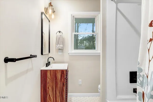 an empty room with a window and wooden floor