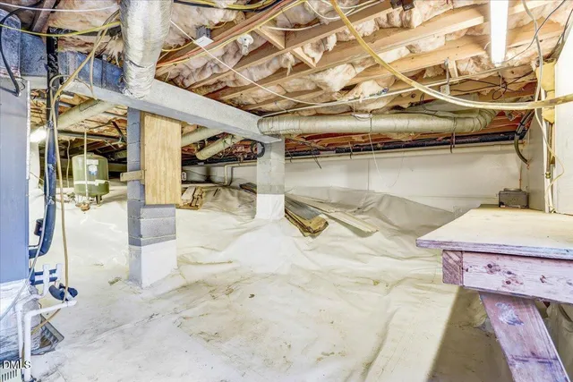 an aerial view of residential house with outdoor space and trees all around