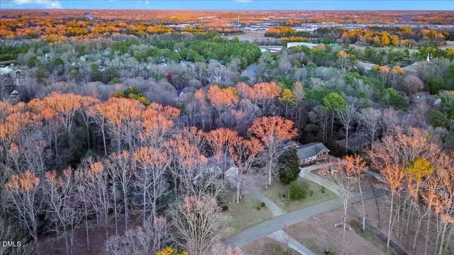 an aerial view of a house with a yard and garden