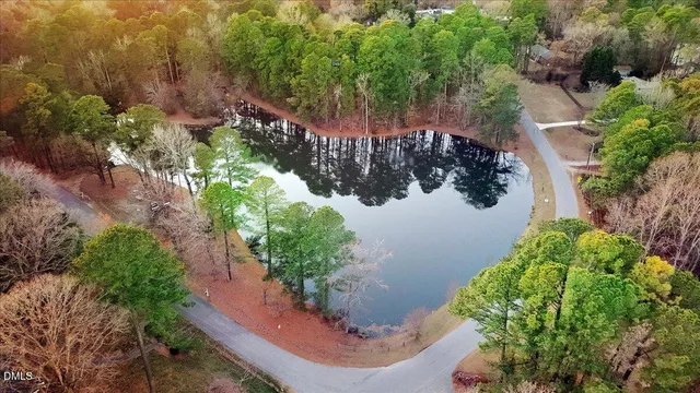 an aerial view of a house with a yard and trees