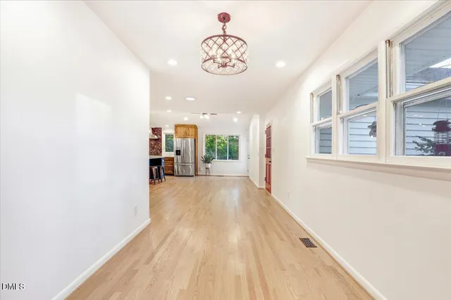 a view of a big room with wooden floor and a large window