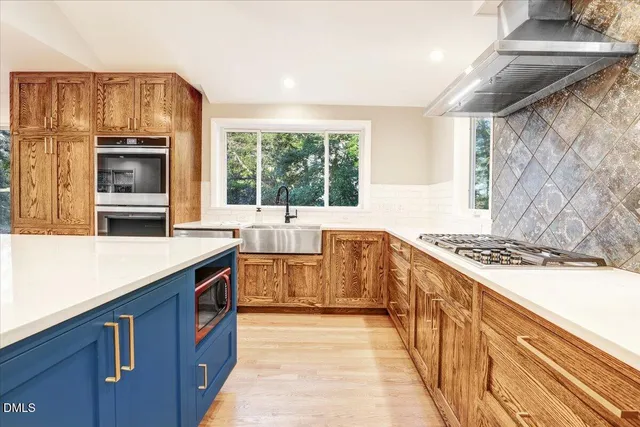 a kitchen with stainless steel appliances a stove and a sink