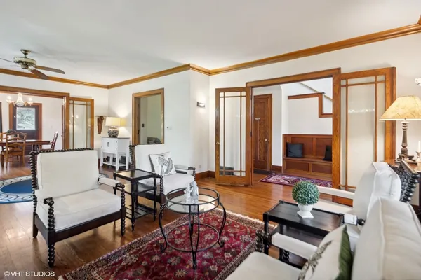 a living room with furniture and a floor to ceiling window