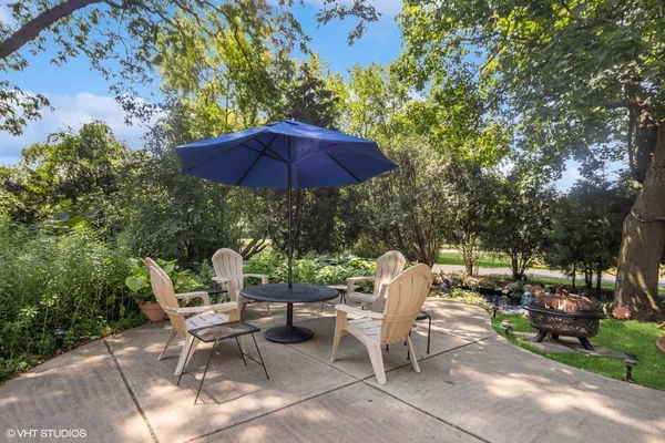 a view of backyard with outdoor seating and trees
