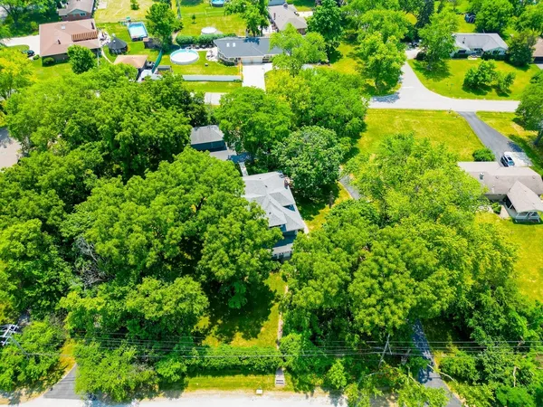 an aerial view of a houses with yard