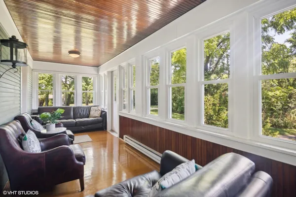 a living room with furniture and large windows