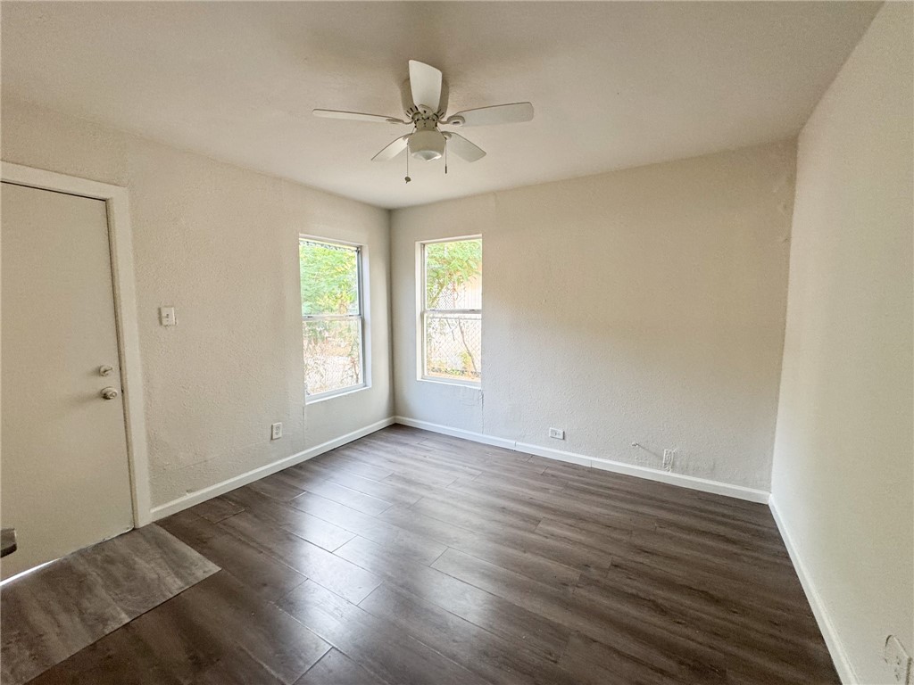 1108 14th Street Corpus Christi, TX 78404 - Photo 2 of 11 a view of an empty room with wooden floor and a window