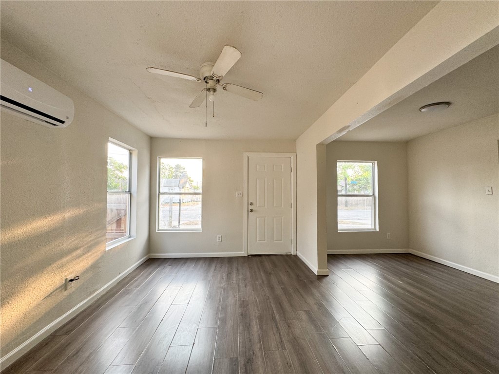 1108 14th Street Corpus Christi, TX 78404 - Photo 4 of 11 a view of empty room with wooden floor and fan