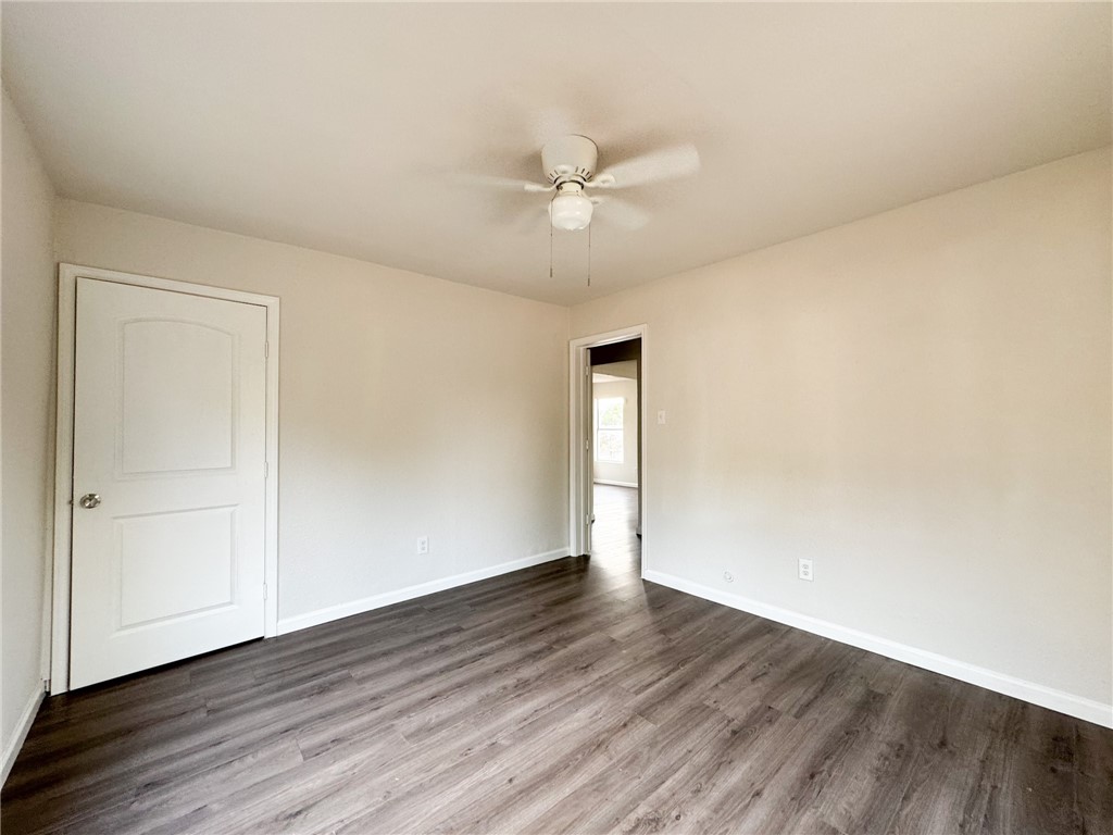 1108 14th Street Corpus Christi, TX 78404 - Photo 8 of 11 an empty room with wooden floor and windows