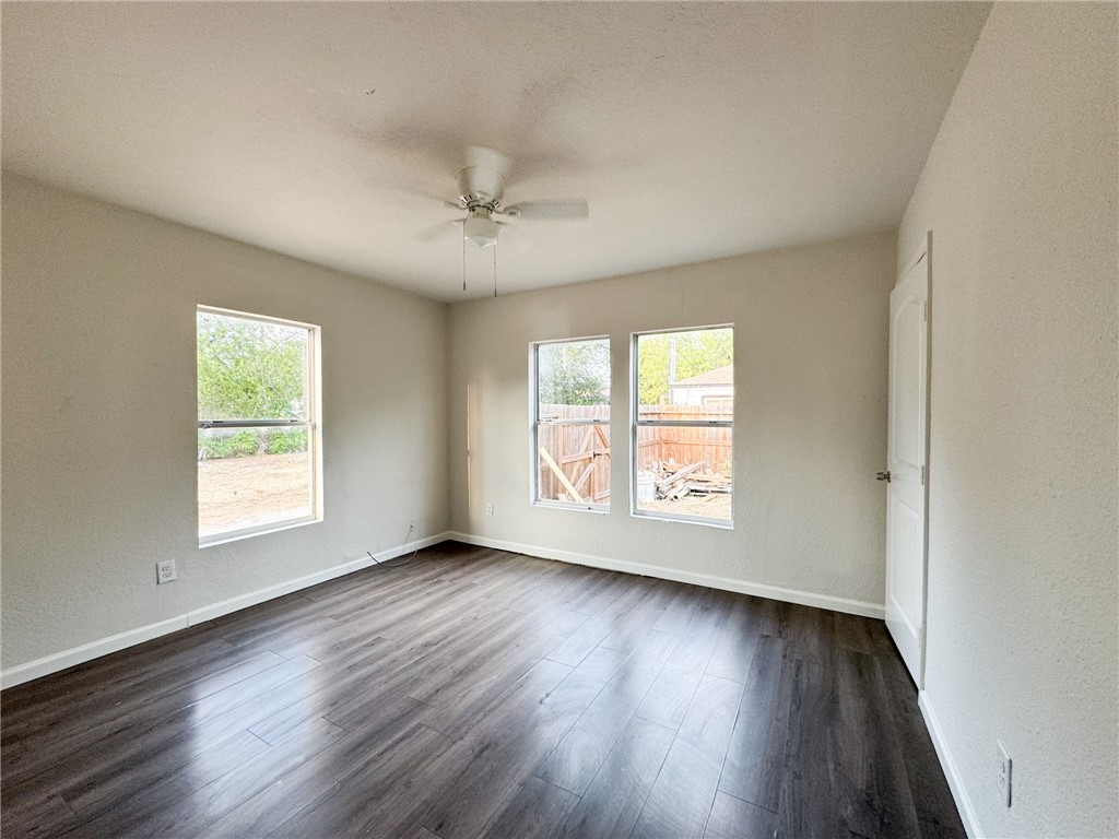 1108 14th Street Corpus Christi, TX 78404 - Photo 10 of 11 a view of an empty room with wooden floor and a window