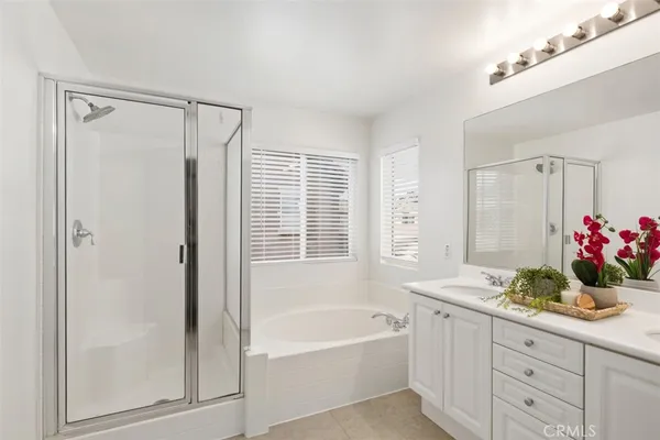 a bathroom with a tub sink and mirror