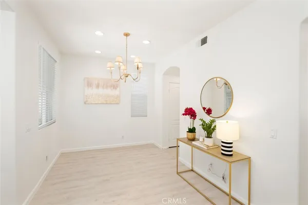 an empty room with windows and cabinet