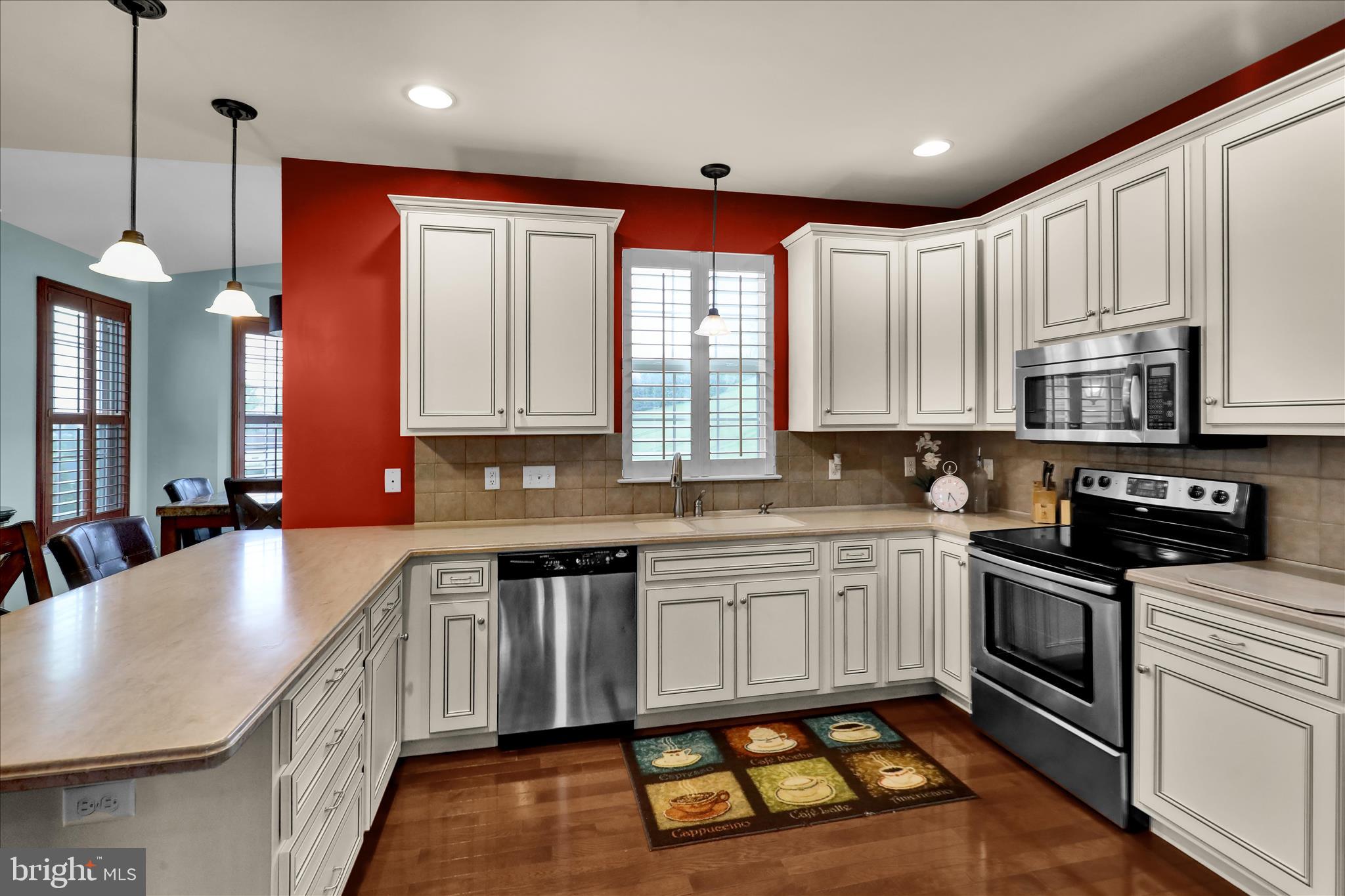 121 Great Bend Way Sinking Spring, PA 19608 - Photo 18 of 59 a kitchen with stainless steel appliances granite countertop a stove a sink and a microwave