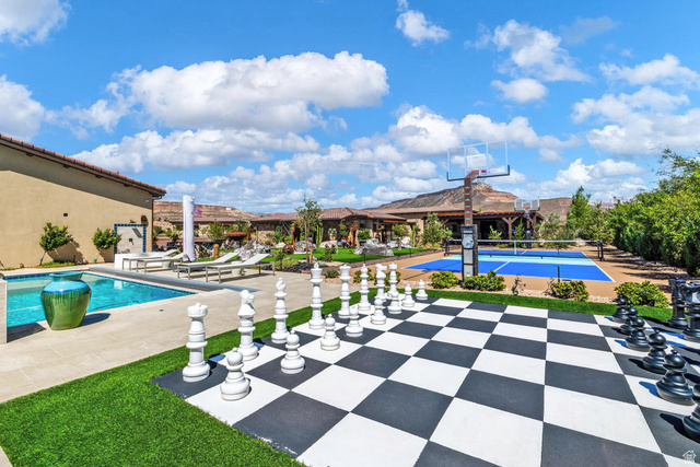 168 South Rancho Santa Fe Virgin, UT 84779 - Photo 48 of 68 Outdoor living space featuring a swimming pool, a large-scale chess board, and a multi-sport court with a basketball hoop