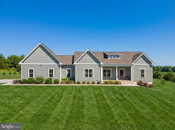 a front view of house with yard and green space
