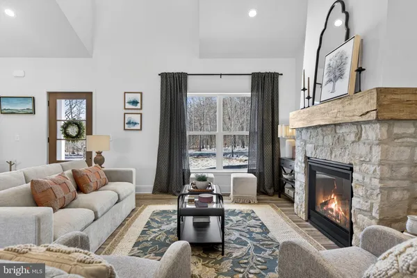 a kitchen with stainless steel appliances granite countertop a sink dishwasher a dining table and chairs with wooden floor