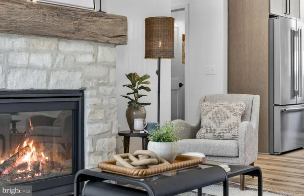 a kitchen with stainless steel appliances granite countertop a sink stove and refrigerator with wooden floor