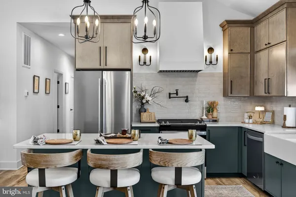 a kitchen with a sink a stove and cabinets