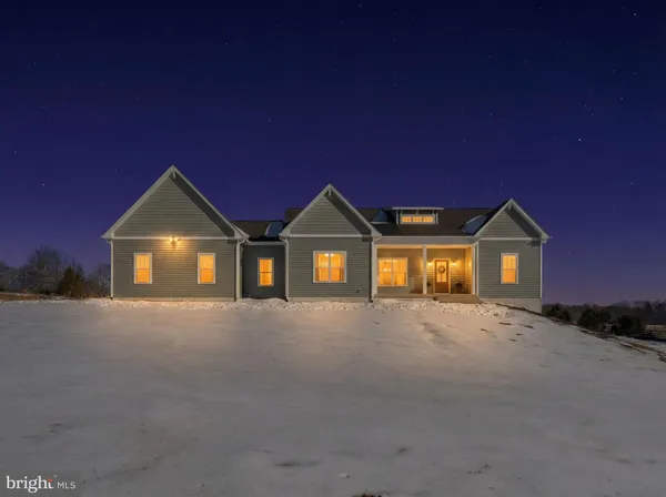 an aerial view of a house with a big yard