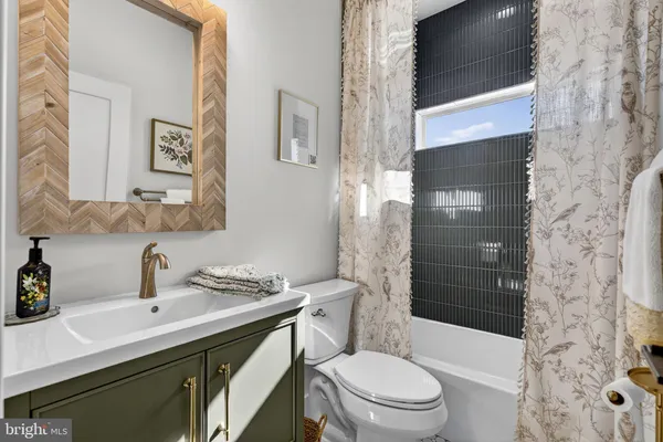 an empty room with wooden floor ceiling fan and windows