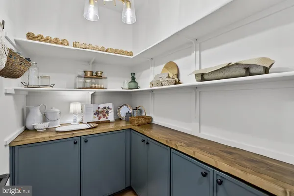 a bedroom with a bed and a dresser next to a window