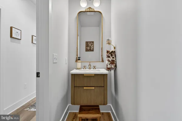 a spacious bathroom with a tub sink and mirror