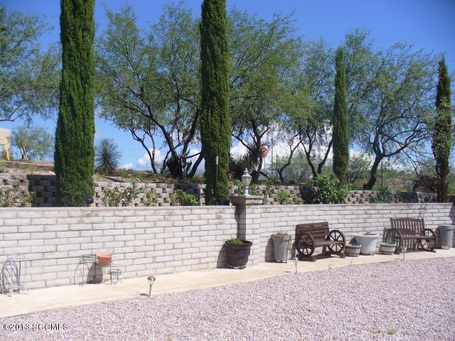 1013 Paseo Guebabi Rio Rico, AZ 85648 - Photo 13 of 19 a view of a bench with trees in front of it
