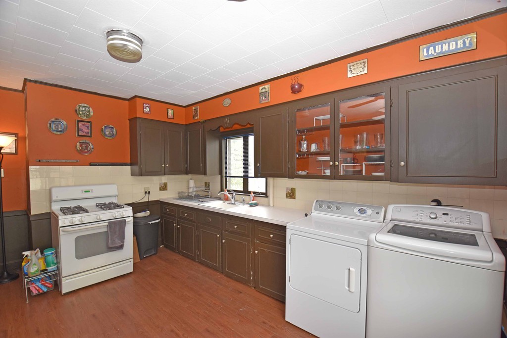 17 Willow Avenue Salem, MA 01970 - Photo 2 of 12 a kitchen with a stove sink and cabinets