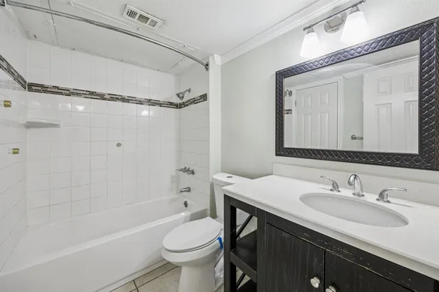 a bathroom with a sink toilet vanity and shower