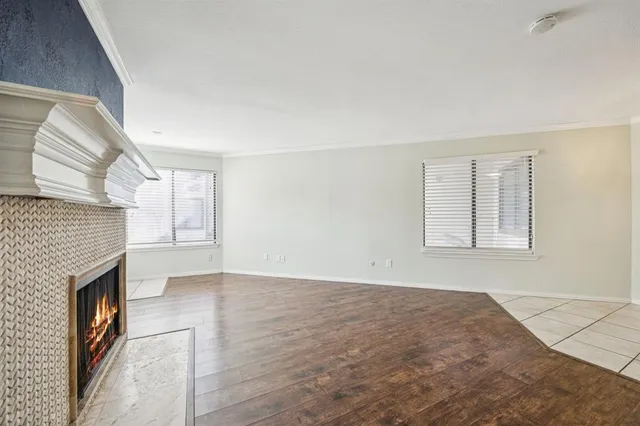a view of an empty room with a fireplace and a window