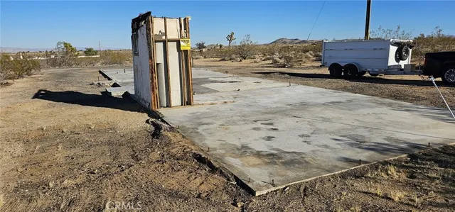 a view of a road with wooden fence