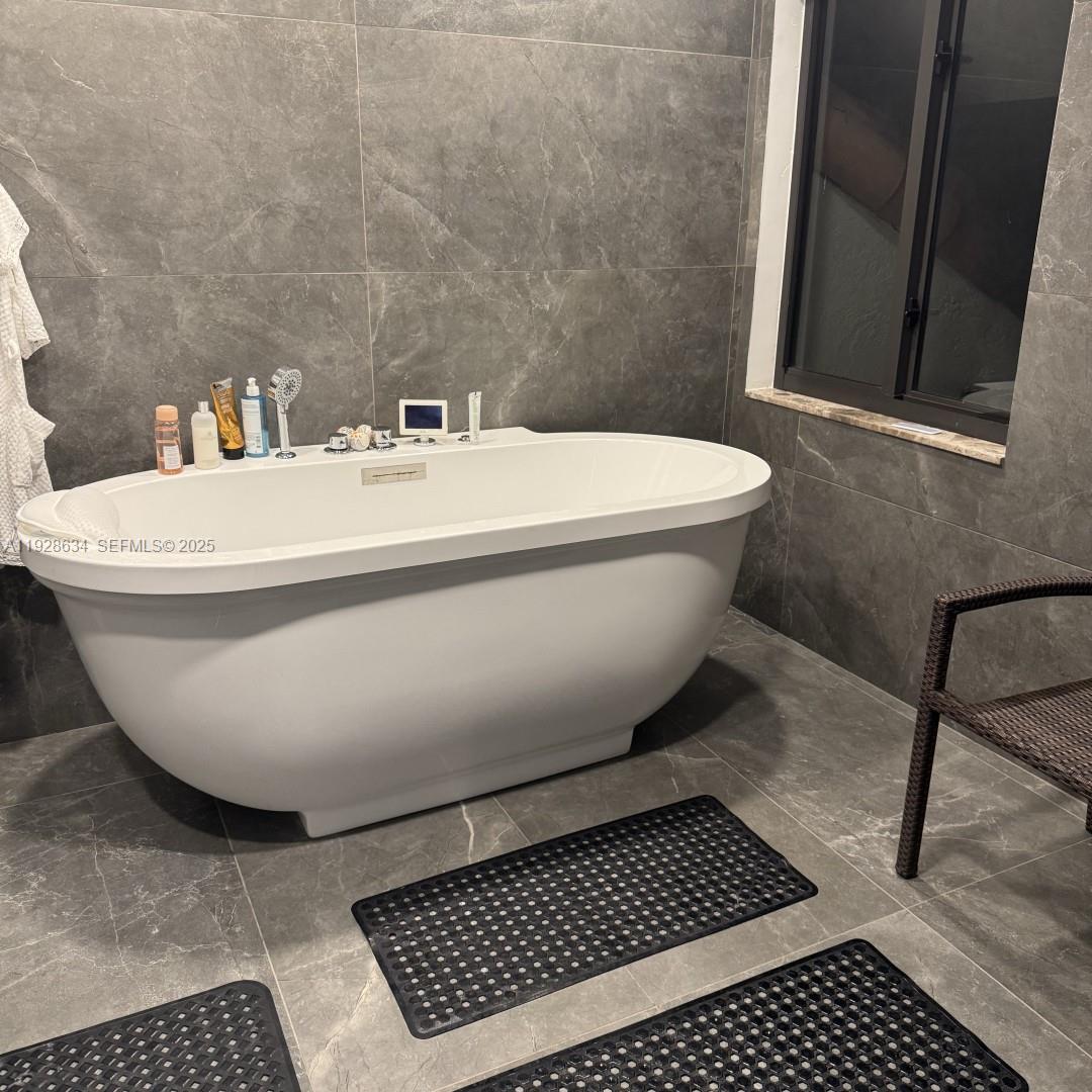 2000 South Bayshore Drive, Unit 46 Miami, FL 33133 - Photo 13 of 15 a white bath tub sitting next to a white toilet