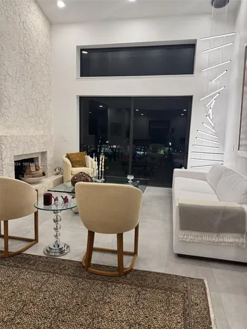 a living room with furniture gym equipment and wall paintings