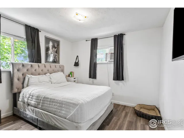 a bedroom with a bed and flat screen tv