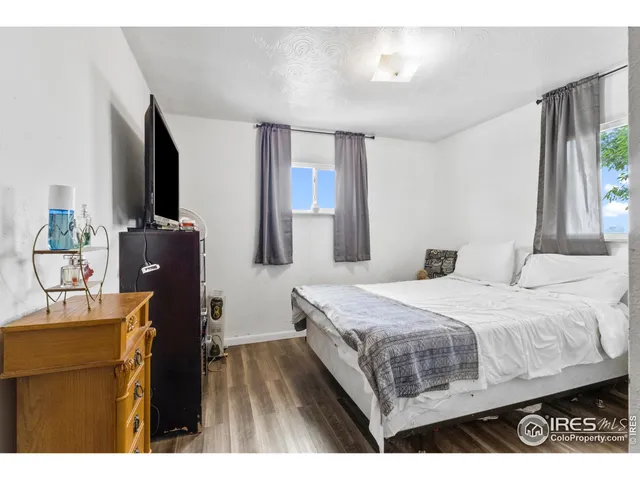 a bedroom with a bed and flat screen tv