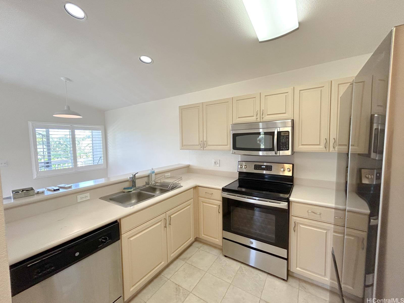 92-1459 Ali'inui Drive, Unit 24A Kapolei, HI 96707 - Photo 2 of 9 a kitchen with appliances a sink and cabinets