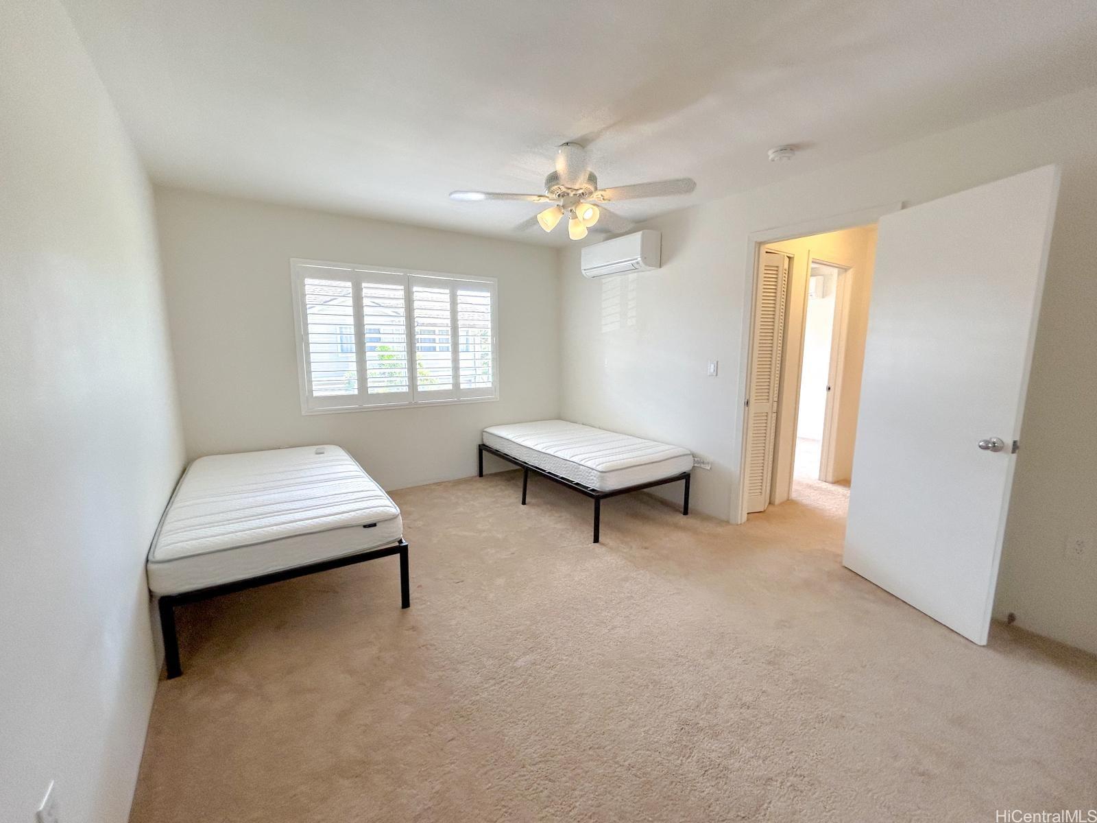 92-1459 Ali'inui Drive, Unit 24A Kapolei, HI 96707 - Photo 3 of 9 a living room with furniture and a window