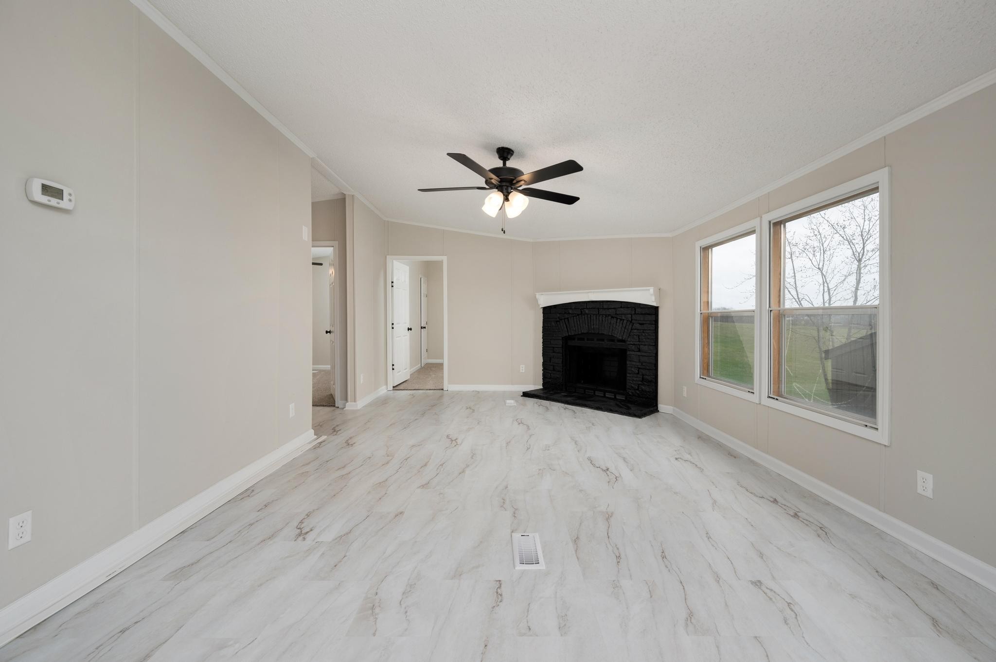 6475 North Pinson Road Portland, TN 37148 - Photo 13 of 23 an empty room with windows and a ceiling fan