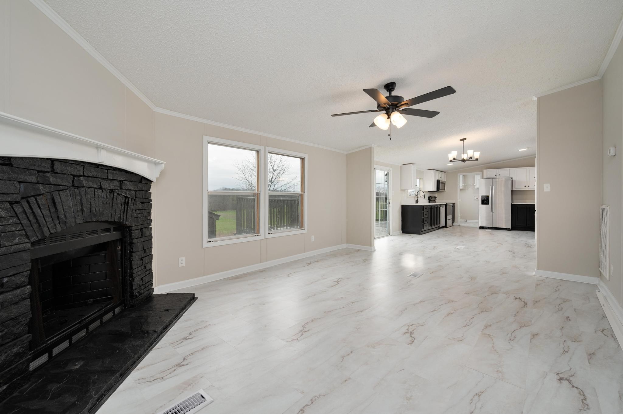 6475 North Pinson Road Portland, TN 37148 - Photo 14 of 23 a view of a livingroom with a fireplace a ceiling fan a fireplace and windows