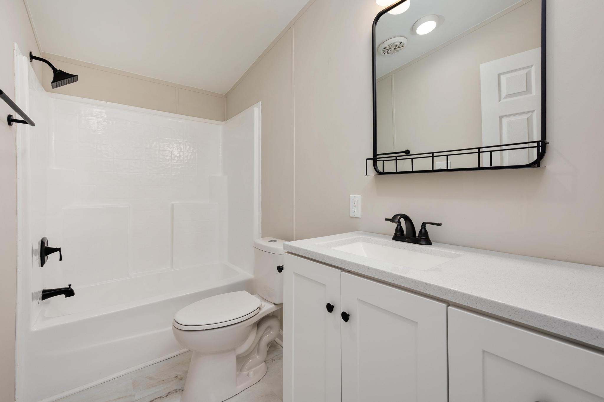 6475 North Pinson Road Portland, TN 37148 - Photo 17 of 23 a bathroom with a granite countertop sink toilet and shower