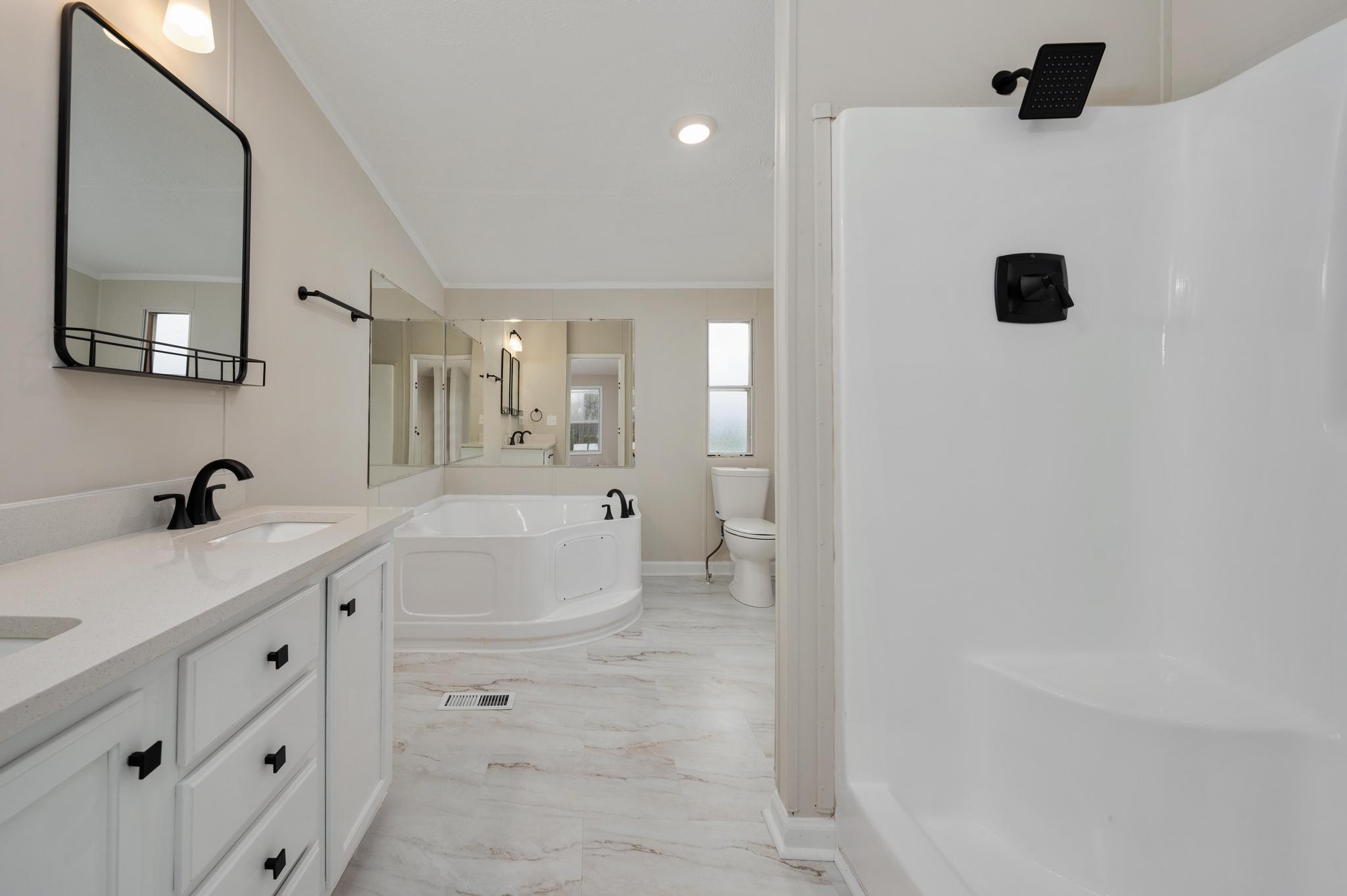 6475 North Pinson Road Portland, TN 37148 - Photo 8 of 23 a bathroom with a double vanity sink a mirror and a bathtub