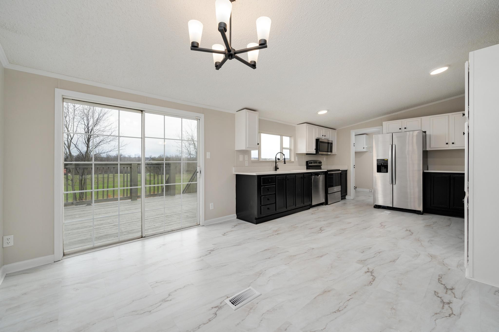 6475 North Pinson Road Portland, TN 37148 - Photo 10 of 23 a view of a kitchen with furniture and a ceiling fan