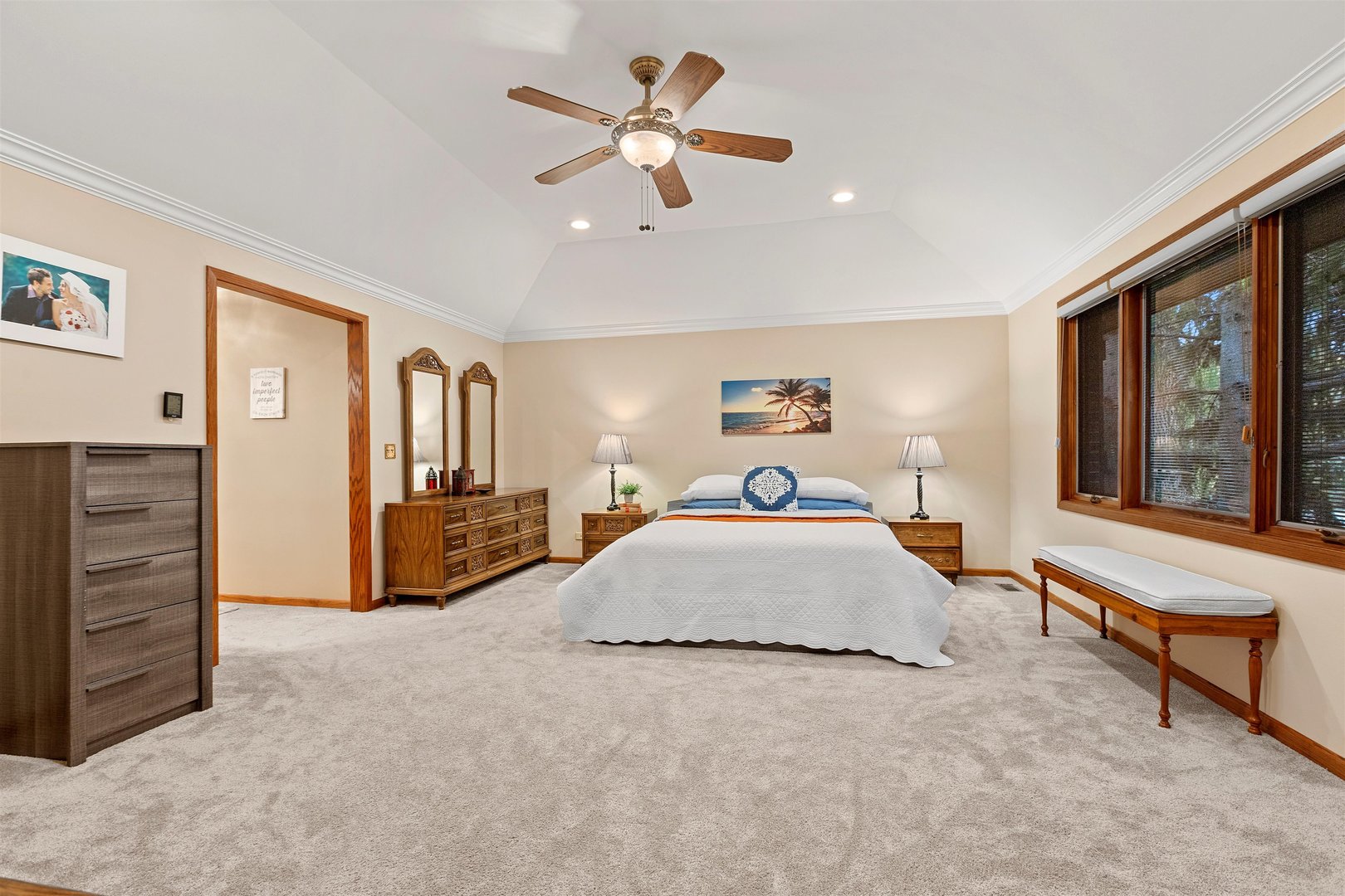 1051 Saunders Road Riverwoods, IL 60015 - Photo 13 of 37 a spacious bedroom with a bed and a chandelier