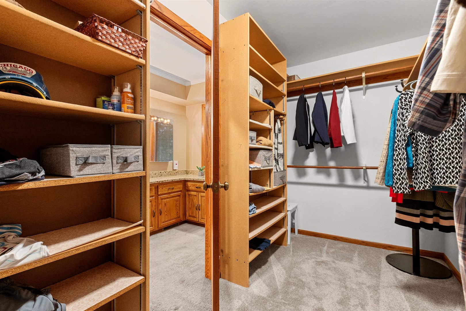 1051 Saunders Road Riverwoods, IL 60015 - Photo 18 of 37 a view of walk in closet with clothes and shoes