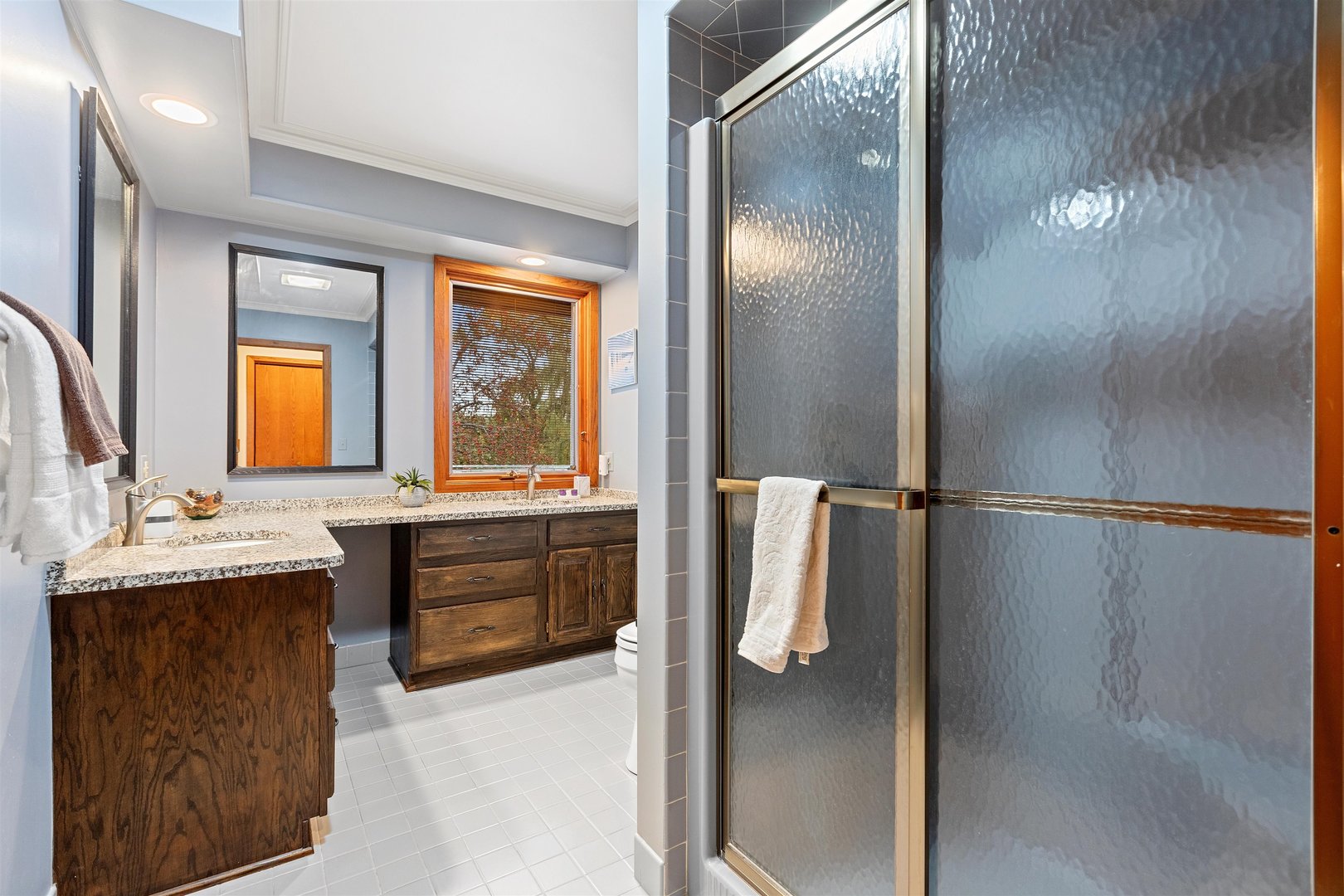 1051 Saunders Road Riverwoods, IL 60015 - Photo 22 of 37 a bathroom with a tub sink and mirror