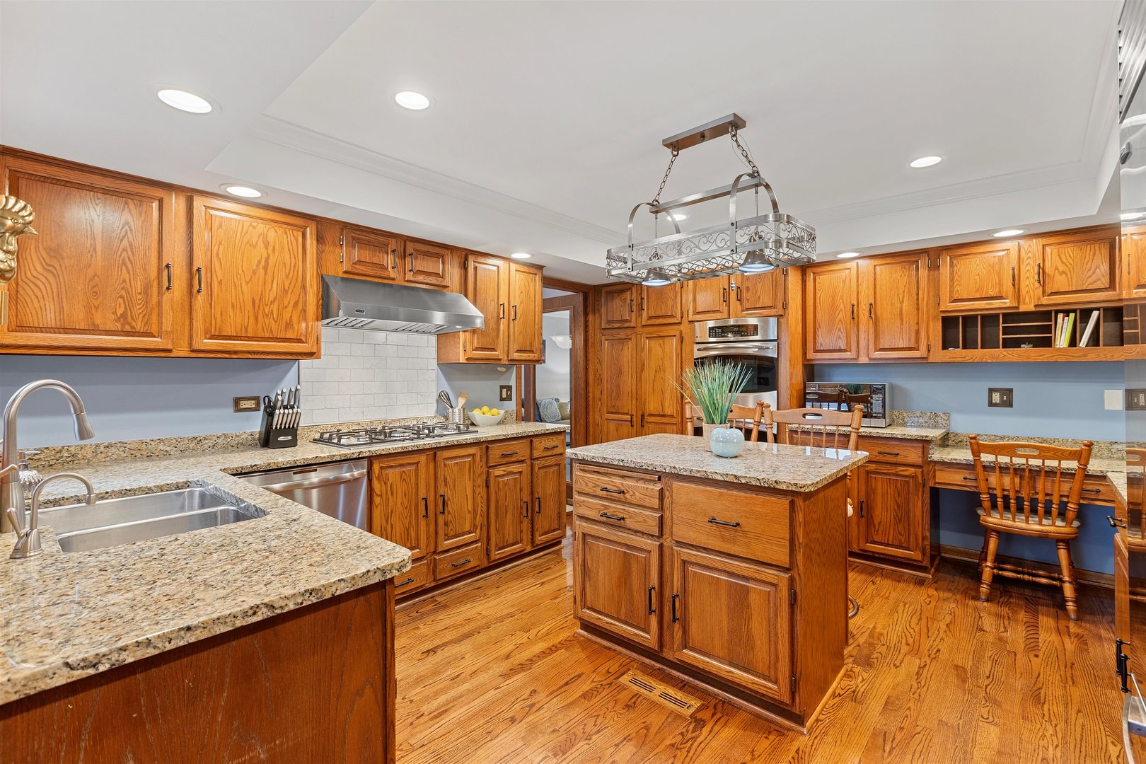 1051 Saunders Road Riverwoods, IL 60015 - Photo 5 of 37 a kitchen with stainless steel appliances granite countertop a sink and cabinets