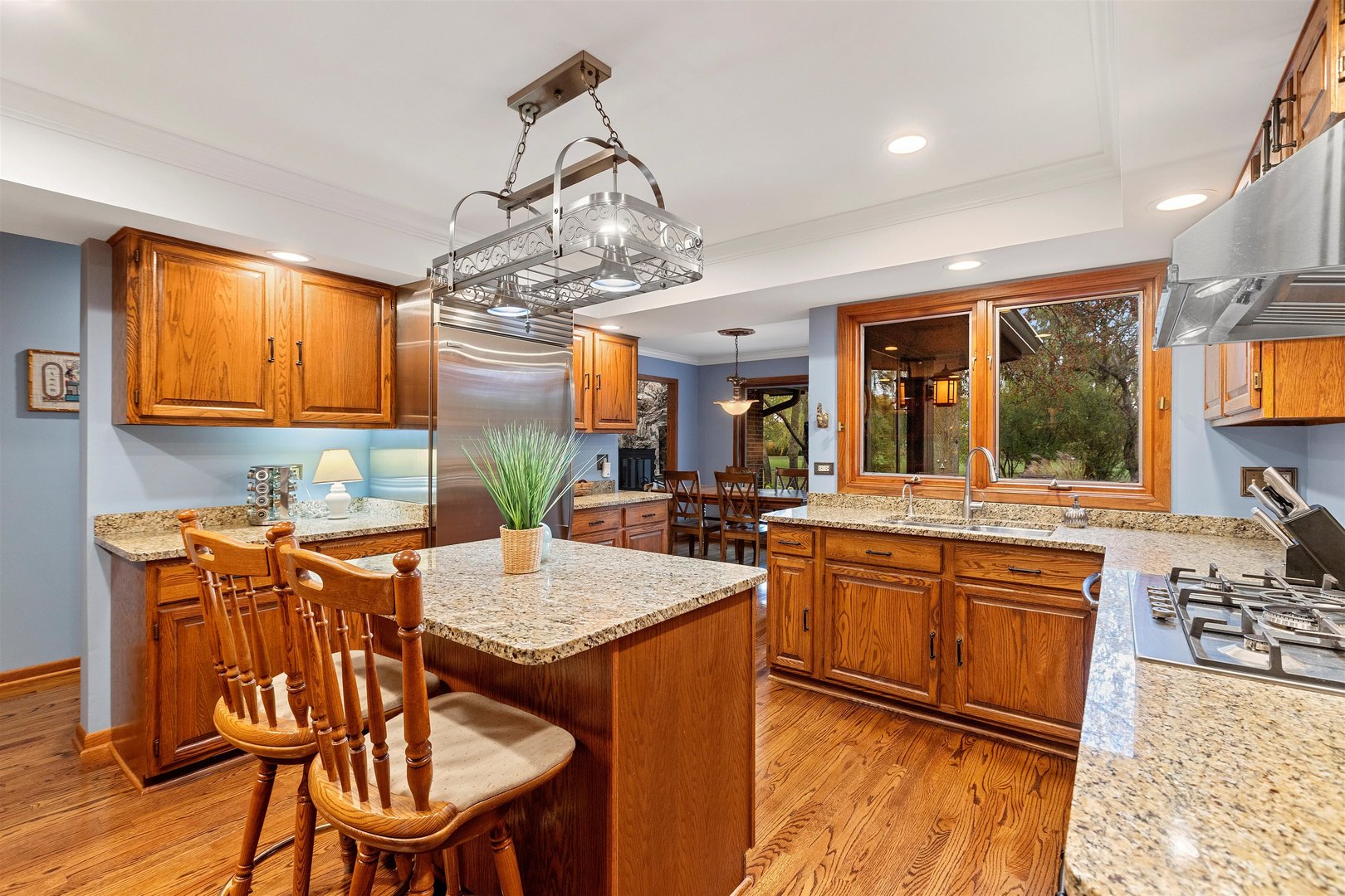 1051 Saunders Road Riverwoods, IL 60015 - Photo 6 of 37 a kitchen with stainless steel appliances granite countertop a sink a stove a dining table and chairs