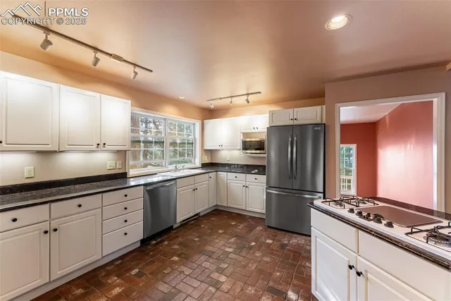 a kitchen with granite countertop cabinets and steel stainless steel appliances